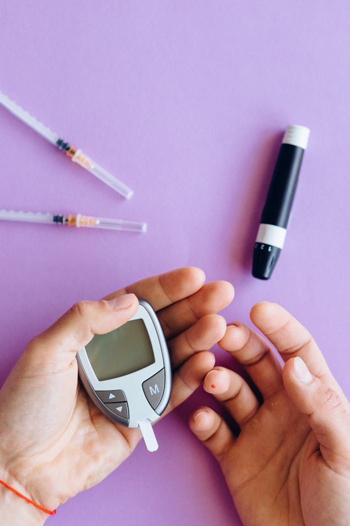 about-me-01 Person holding glucose meter with syringes on a purple surface, health concept.