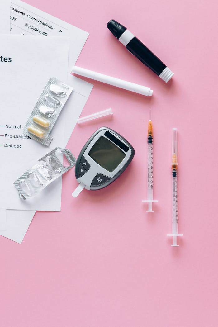 why-choose-us-02 Diabetes testing kit with glucose meter and syringes on pink surface.